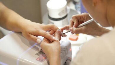 cuticle tool lifting soft gel from a nail, part of how to remove gel x nails at home