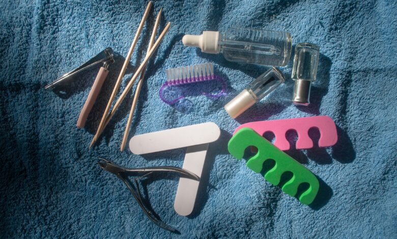 A flat lay of manicure tools like files clippers cuticle sticks and oil used for how to remove builder gel at home