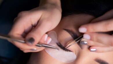 Woman gently removing eyelash extensions at home using a safe, damage-free method without pulling her natural lashes.