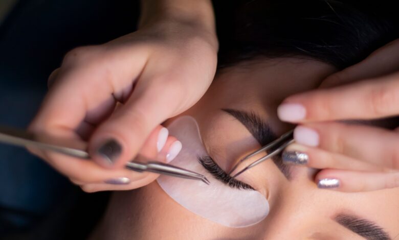 Woman gently removing eyelash extensions at home using a safe, damage-free method without pulling her natural lashes.
