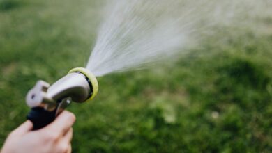 Homeowner checking a faucet with low water pressure while learning practical ways to improve water flow at home.