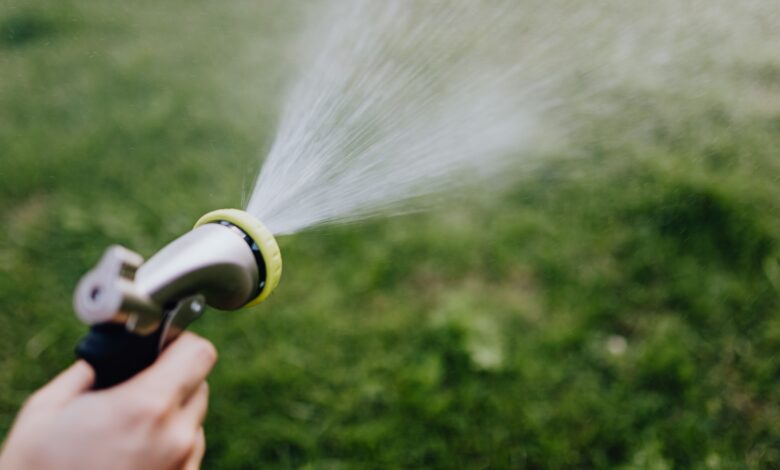 Homeowner checking a faucet with low water pressure while learning practical ways to improve water flow at home.