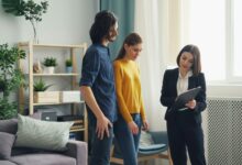 How long does a home inspection take shown by a couple reviewing findings with an inspector holding a clipboard