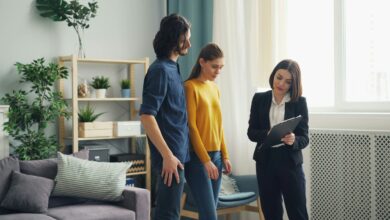How long does a home inspection take shown by a couple reviewing findings with an inspector holding a clipboard