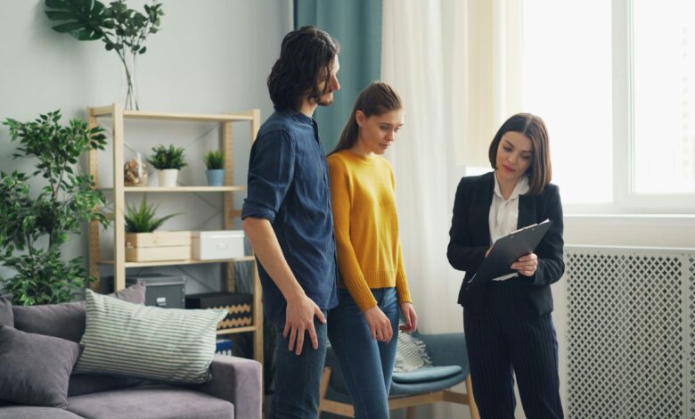 How long does a home inspection take shown by a couple reviewing findings with an inspector holding a clipboard