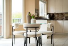Home decor ideas for small homes shown in a cozy round dining nook with boucle chairs and a glass table