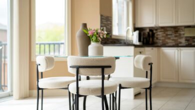 Home decor ideas for small homes shown in a cozy round dining nook with boucle chairs and a glass table