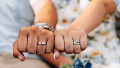 A wedding ring being safely cleaned at home using warm water, mild soap, and a soft-bristled brush