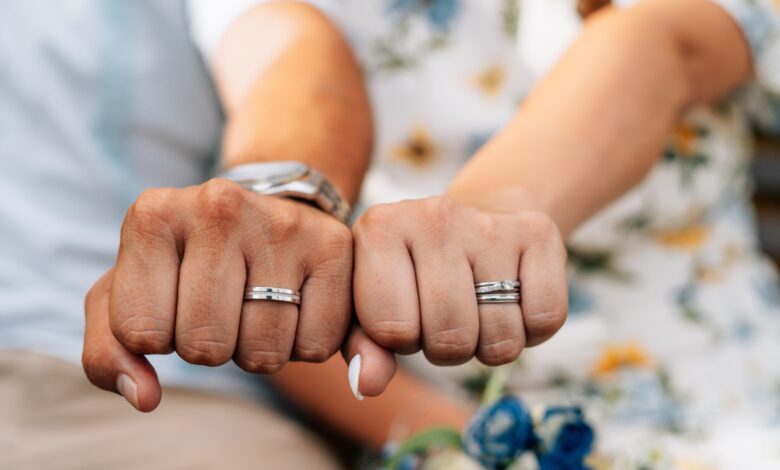 A wedding ring being safely cleaned at home using warm water, mild soap, and a soft-bristled brush