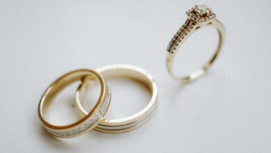 A person gently cleaning rings at home using a soft brush, warm water, and mild soap.